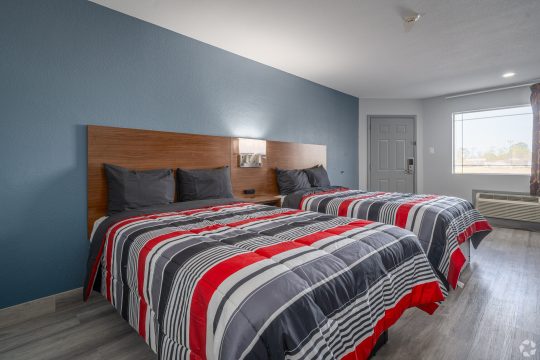 two beds studio apartment with blue walls at The Studios At Channelview